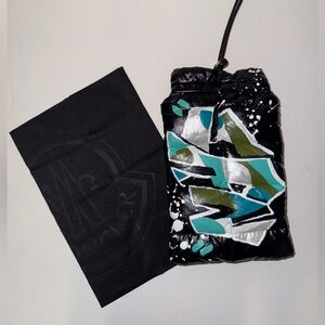 Moncler silver, teal and blue hand painted graffiti “NYC” puffer sunglass case